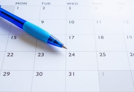 Blue pen on calendar page background business planning appointment meeting concept